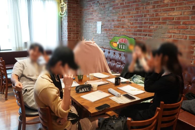 테이블에 둘러앉아 자료를 펼쳐놓은 참여자들